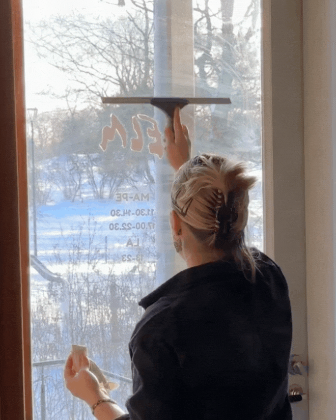 washing the window at restaurant elm