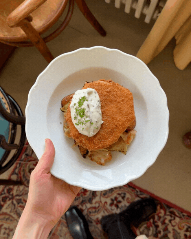 Schnitzel on white plate at restaurant Elm